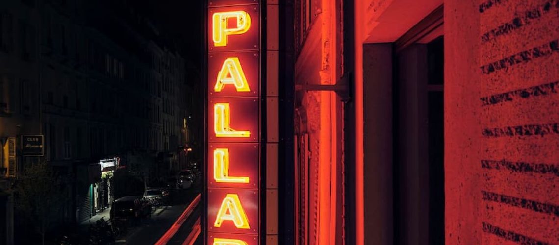 Historic Bus Palladium neon sign on the Paris hotel facade at night by Studio KO