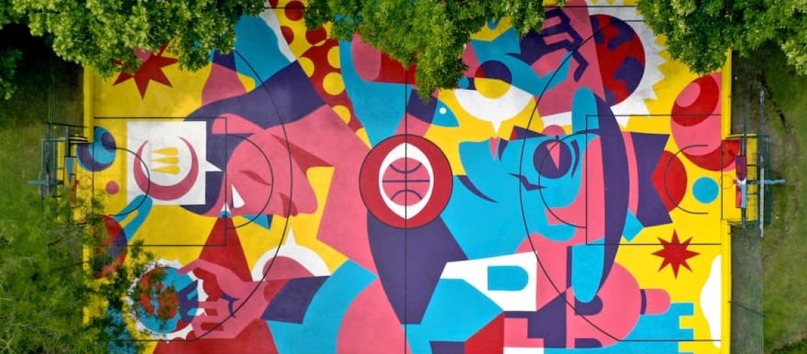 A Pair of Vibrant, Color-Blocked Murals Transform Two Basketball— Artist Lakwena transforms Pine Bluff basketball courts into vibrant murals with "Still I rise" & "Make it rain," honoring the local Black community. Courts in Arkansas